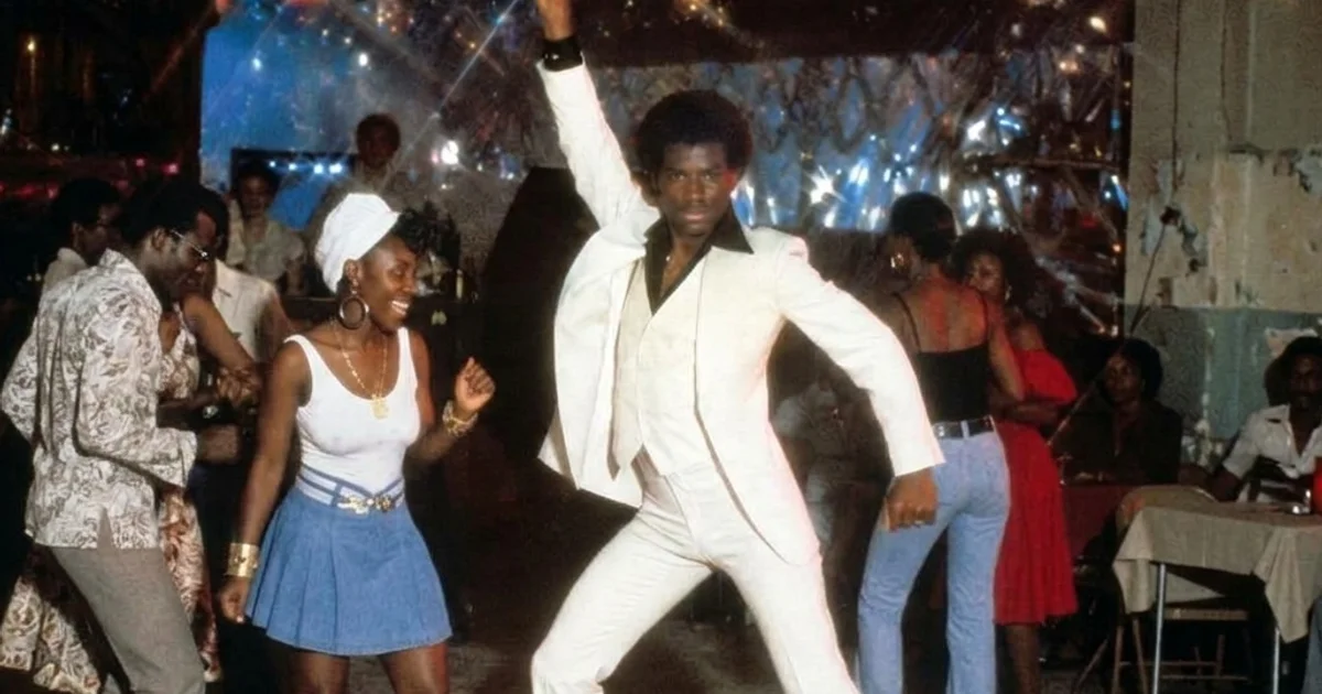 Vintage Disco - man in white suite striking a dance pose
